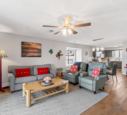 Living room w/ queen memory foam sleeper sofa. Smart TV on opposite wall. 