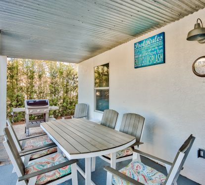 Covered sitting area by the pool / Grill.  Outdoor shower around the corner.