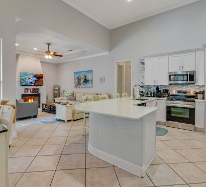 Kitchen has breakfast bar and an extra table