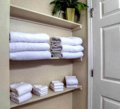 Shelf where additional linens are stored