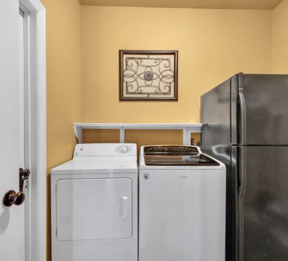 Laundry room with 2nd refrigerator.  