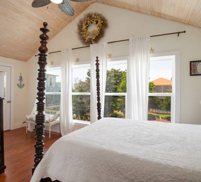 Upstairs BR with queen bed, tv, balcony and ensuite bath.