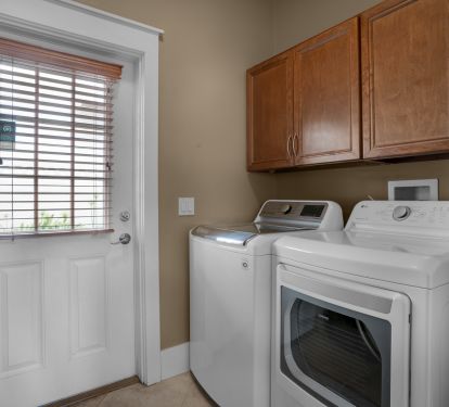 Great laundry room and access to the fenced in backyard.