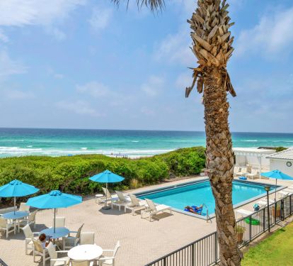 View of pool, dunes, and gulf from balcony