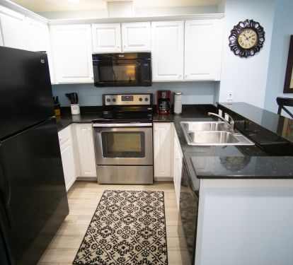 Kitchen stocked with dishes, pots/pans, utensils, and even some seasonings