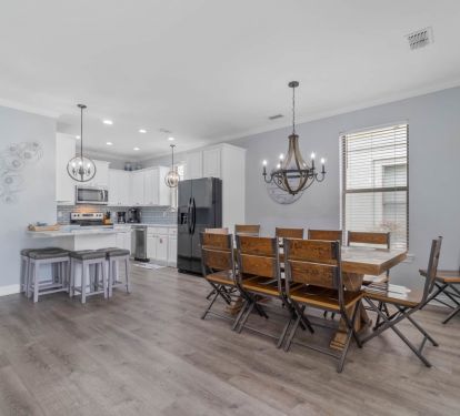 Dining room with seating for 10 and barstools at the kitchen counter