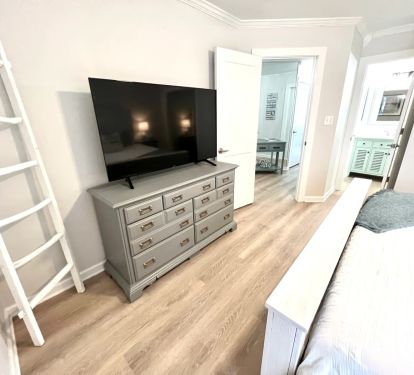 Master Bedroom with 55-in Smart TV, Full-size Dresser and towel ladder