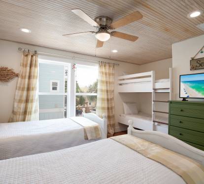 Upstairs BR with two twin beds and two twin bunk beds - room sleeps 4 total.