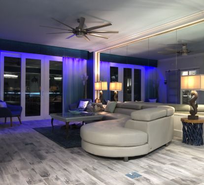 Gorgeous living room leather couch with blue accent lighting 