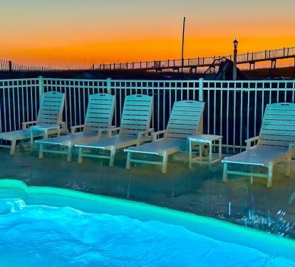 Enjoy the heated lit beachside pool under a soft glowing twilight sky!