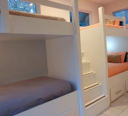BR 5 Bunkroom has 4 twin beds, night lights and storage drawers.