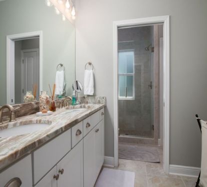 En suite master bath with dual vanity and separate toilet/shower area