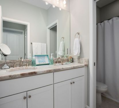 First floor full bathroom has double sinks and separate shower/toilet area