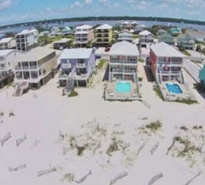 House from sky. Water you see 2 streets over is the lagoon. Beach by house 