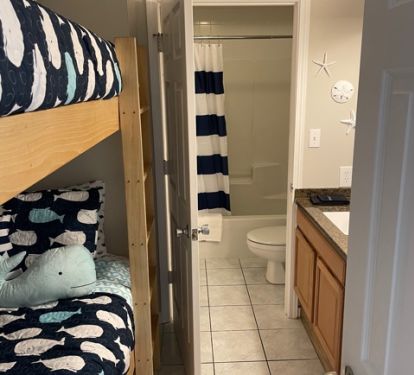 Bunks located next to vanity. There is a door to allow for privacy 