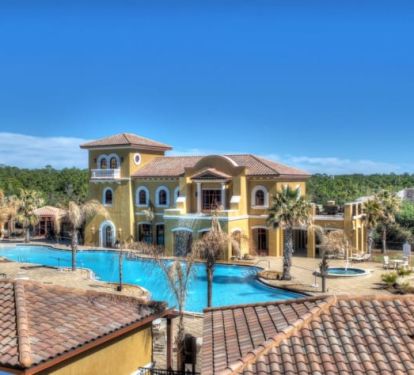 View of huge swimming pool club house from the front door of the condo