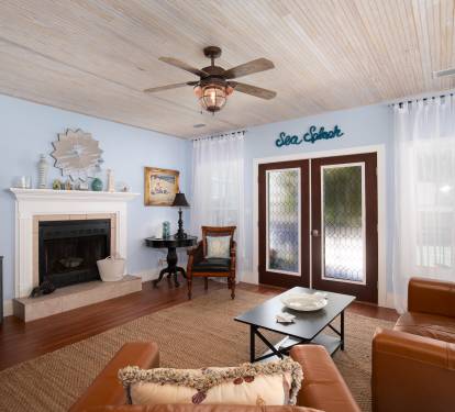 Family room with large tv and plenty of seating.