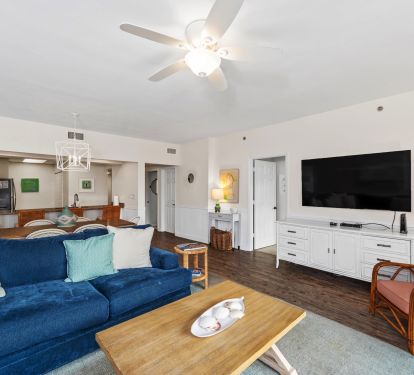 Spacious living area with comfortable seating and large screen tv.