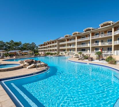 Our 4 pool 2 hot tub pool deck follows the shape of our 64 unit complex