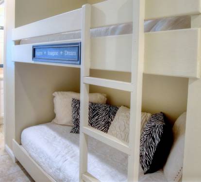 Another view of bunks and door to hall half bath and shower/laundry room