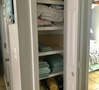 Linen closet stores extra sheets, towels and beach towels. 