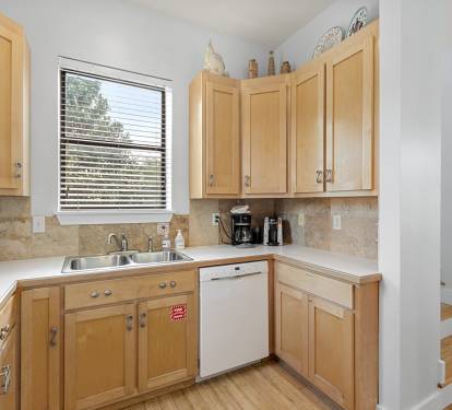 Fully-stocked kitchen with dishwasher, toaster, and coffee maker