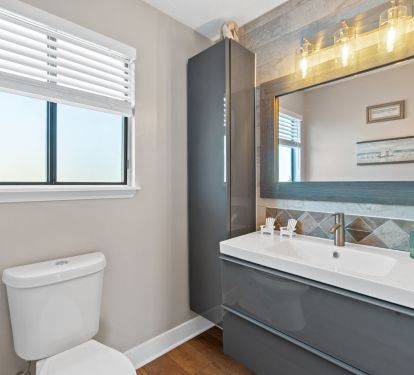 Powder room on main level off kitchen area 
