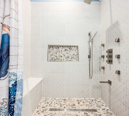 Well-appointed loft bathroom with a multi-jet shower and TOTO Washlet&mdash;comfort and quality throughout.
