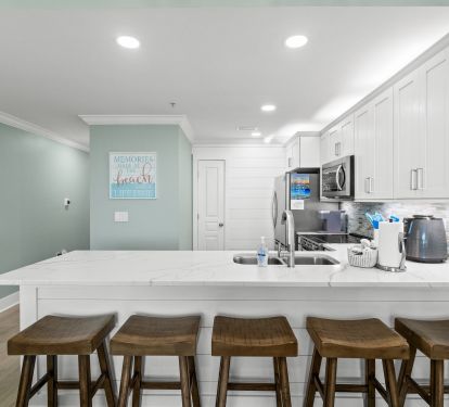 All-new coastal kitchen with sleek quartz island that seats 5 