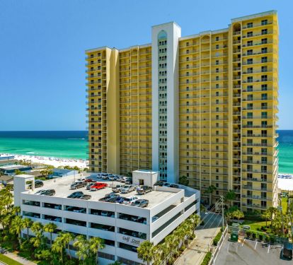 Street view of beautiful Gulf Crest Condominiums and attached parking complex
