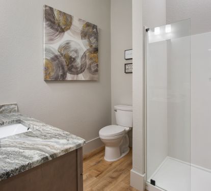 Private bathroom has glassed in shower