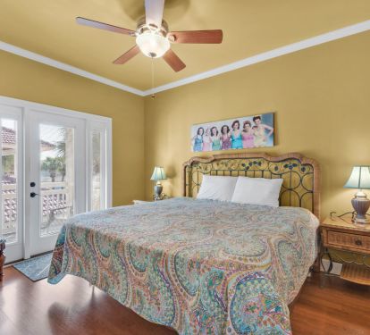 Upstairs king bedroom with access to covered balcony porch.
