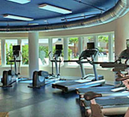 Fitness Center overlooks courtyard and pools.