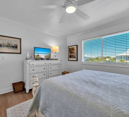 2nd guest bedroom with flat screen tv and ceiling fan