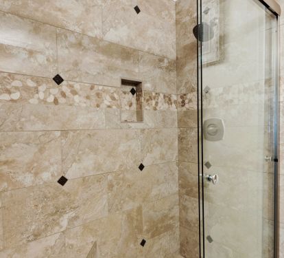Walk-in shower adjacent with 2nd bedroom with porcelain tile and river rock