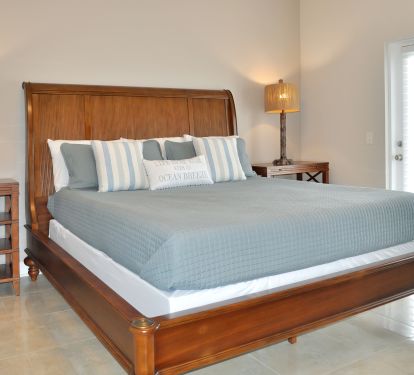Master suite with California King bed and doors that lead to the front deck
