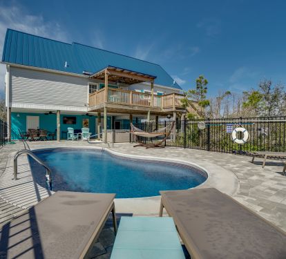 Pool area and covered back deck. Relax in a lounger or the hammock!
