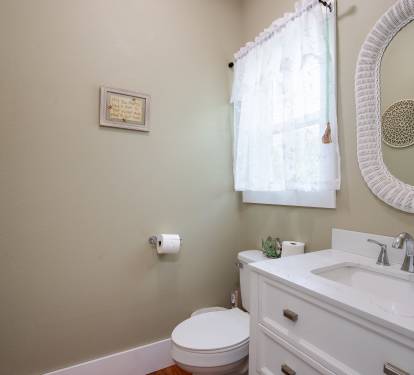 Half bath conveniently located just off the kitchen.