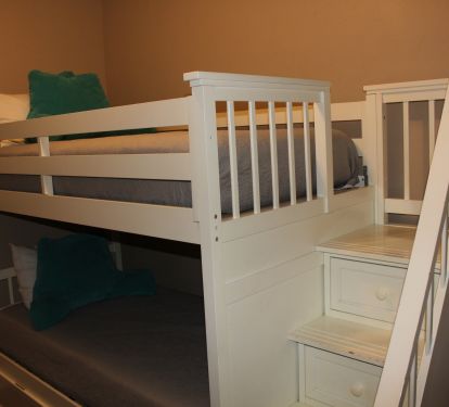 The bunk bed has safety in mind with railings and a stairs