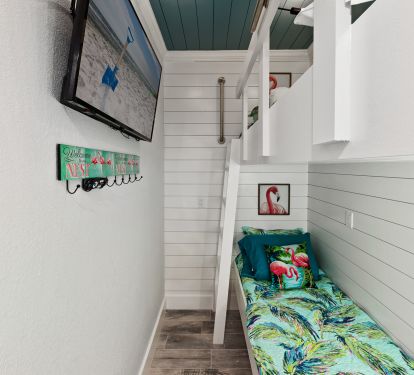 Bunk nook room featuring single over single bunks &amp; 50&rdquo; tv