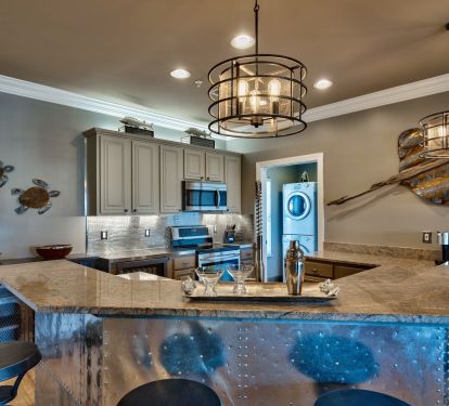 Kitchen with NOLA faucet, zero radius sink and stainless appliances.