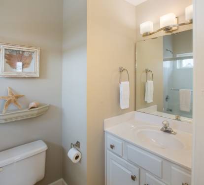 Private bath with shower/tub combination connects to queen bedroom. 