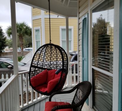 The front wraparound porch with swing and rocking chairs.