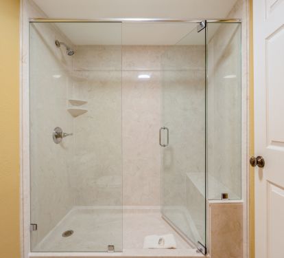 The master bath has a newly upgraded shower with large frameless glass door