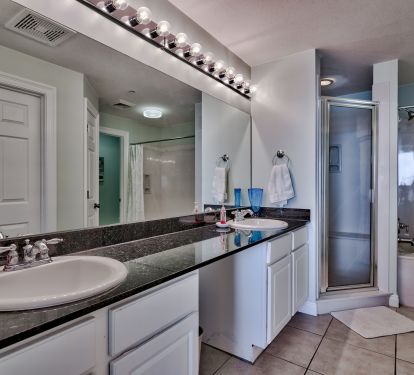 Master bathroom featuring dual sink, tub and shower
