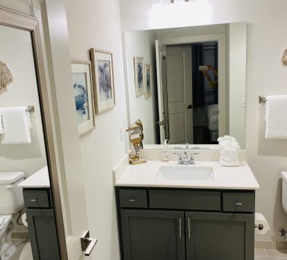 Ensuite master bath has glass enclosed shower with built-in seat.  
