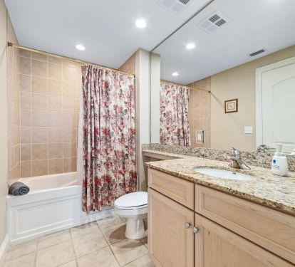 Bath with tub and shower, adjacent to guest room, and hallway