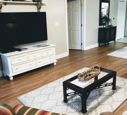 Comfortable furniture and 65" TV in living room