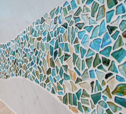 A custom wave mosaic design creates a one of a kind accent in the kitchen