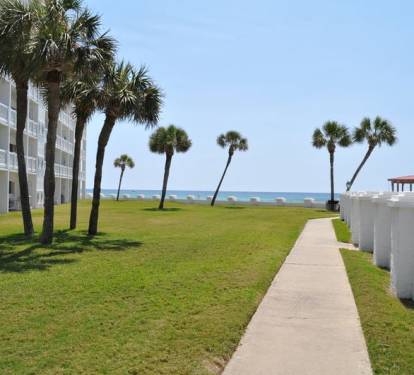 Ground Level patio (left) near beach and pool (right) - El Matador Resort, Okaloosa Island Fort Walton Beach Vacation Rentals